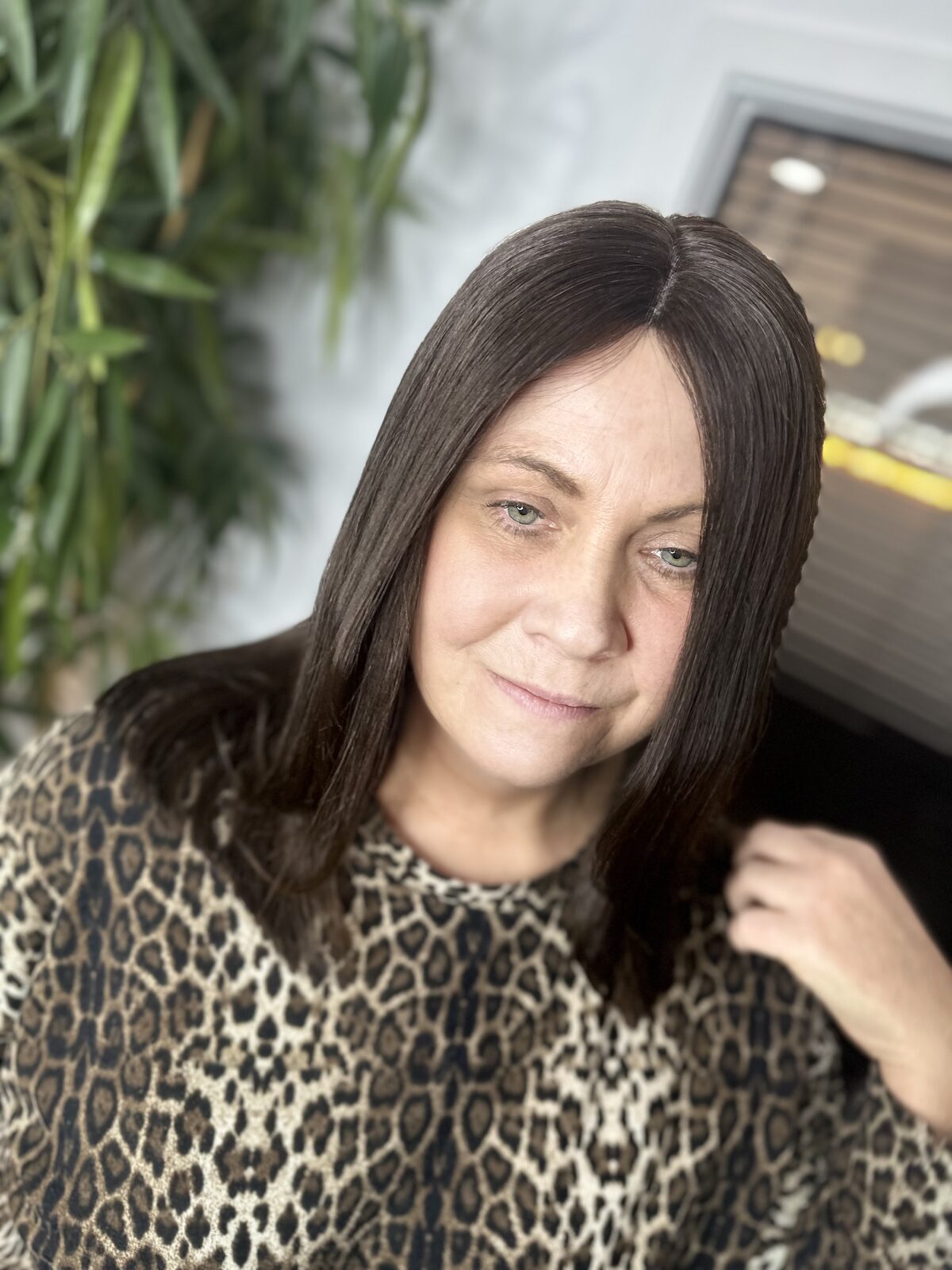 Sleek brunette hair result on a hair loss client